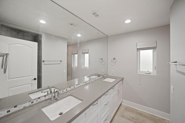 5135 Loch Lomond Dr, Houston, TX 77096 - bathroom featuring double vanity, plenty of natural light, recessed lighting, and tile patterned flooring