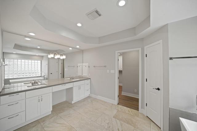 5135 Loch Lomond Dr, Houston, TX 77096 - bathroom featuring double vanity, a raised ceiling, recessed lighting, a tub to relax in, and a closet