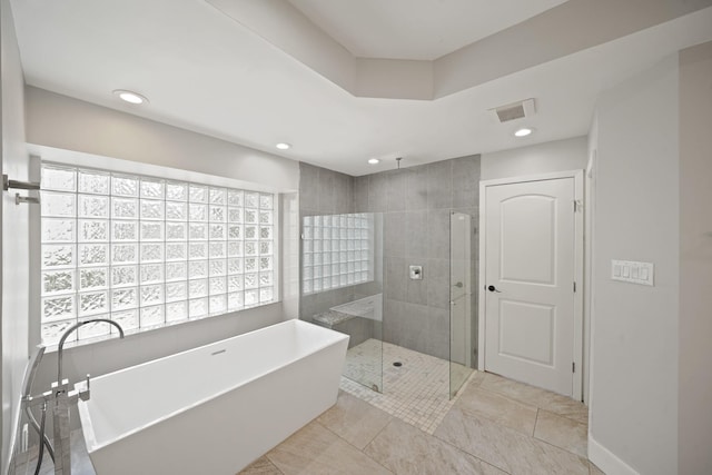 5135 Loch Lomond Dr, Houston, TX 77096 - full bath featuring a soaking tub, a tile shower, recessed lighting, healthy amount of natural light, and tile patterned flooring