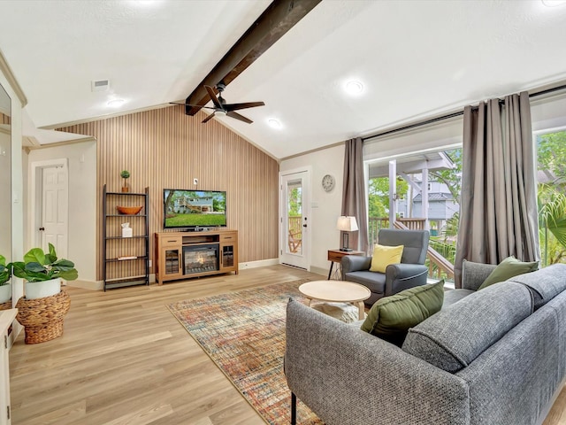 1002 Staples Ave, Seabrook, TX 77586 - living room with ceiling fan, wood finished floors, plenty of natural light, and wood walls