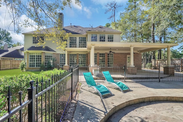 13810 Lakewood Crossing Blvd, Houston, TX 77070 - rear view of house featuring brick siding, a patio, a ceiling fan, and a chimney