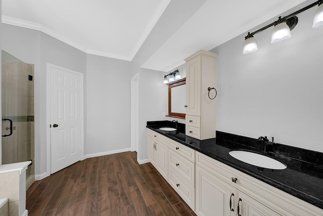 13810 Lakewood Crossing Blvd, Houston, TX 77070 - bathroom featuring double vanity, ornamental molding, a stall shower, and wood finished floors