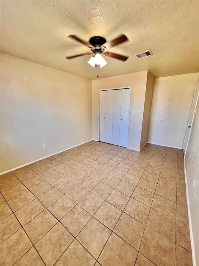 14634 Edenglen Dr, Houston, TX 77049 - unfurnished bedroom featuring a textured ceiling, light tile patterned floors, ceiling fan, and a closet