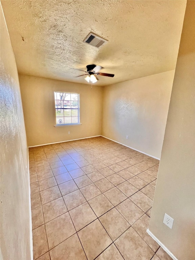 14634 Edenglen Dr, Houston, TX 77049 - empty room featuring light tile patterned floors, a ceiling fan, and a textured ceiling