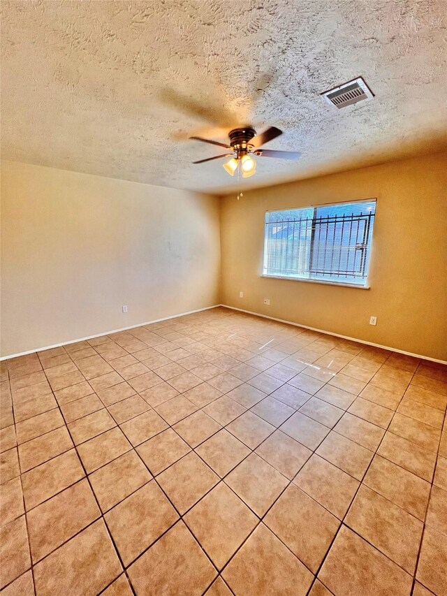 14634 Edenglen Dr, Houston, TX 77049 - unfurnished room featuring light tile patterned floors, a textured ceiling, and ceiling fan