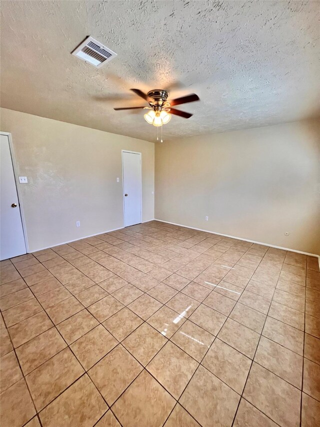 14634 Edenglen Dr, Houston, TX 77049 - unfurnished room featuring light tile patterned floors, a textured ceiling, and ceiling fan