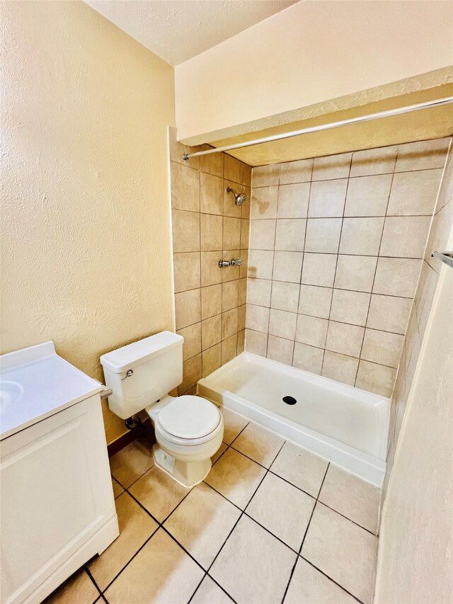 14634 Edenglen Dr, Houston, TX 77049 - full bath with tiled shower, tile patterned floors, vanity, and a textured wall