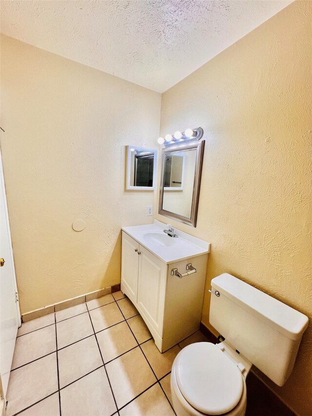 14634 Edenglen Dr, Houston, TX 77049 - half bathroom with vanity, a textured ceiling, tile patterned floors, and a textured wall