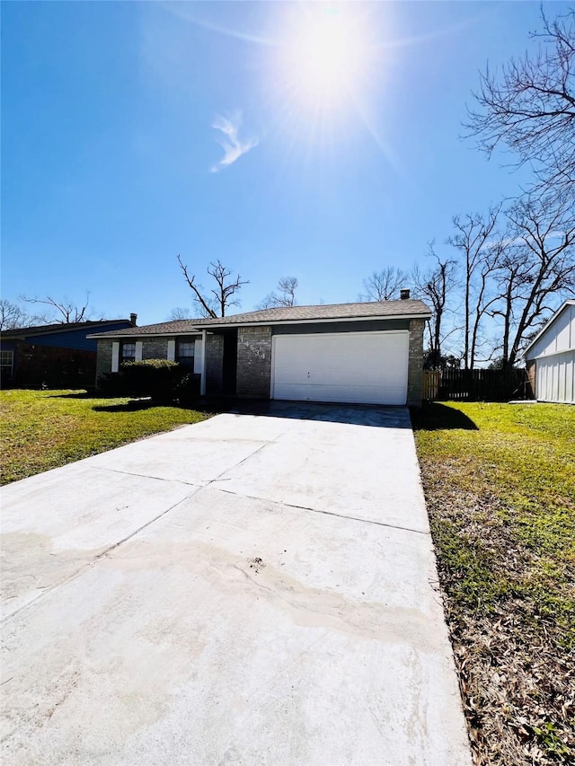 14634 Edenglen Dr, Houston, TX 77049 - view of front of property featuring driveway, a garage, a chimney, and brick siding