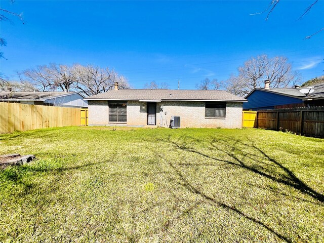 14634 Edenglen Dr, Houston, TX 77049 - rear view of house featuring a fenced backyard, brick siding, and a chimney