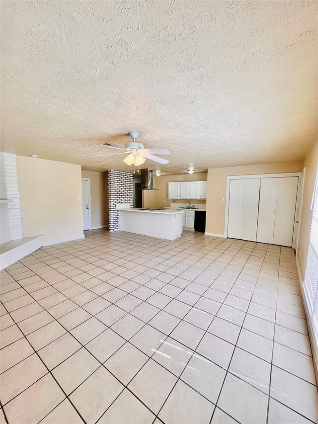 14634 Edenglen Dr, Houston, TX 77049 - unfurnished living room with a textured ceiling, a ceiling fan, and light tile patterned flooring