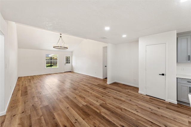 7815 Brook Trail Cir, Houston, TX 77040 - unfurnished living room featuring a chandelier, light wood finished floors, and recessed lighting