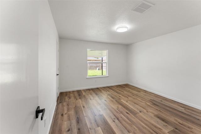 7815 Brook Trail Cir, Houston, TX 77040 - unfurnished room featuring wood finished floors and a textured ceiling