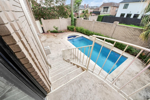 1425 Nantucket Dr Unit G, Houston, TX 77057 - view of swimming pool featuring a fenced backyard, a pool with connected hot tub, a patio, and a residential view