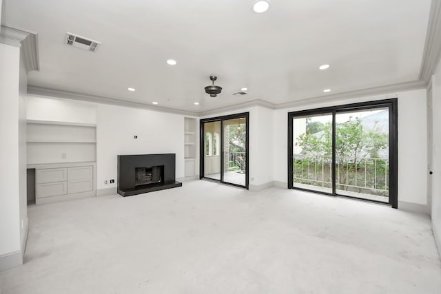 1425 Nantucket Dr Unit G, Houston, TX 77057 - unfurnished living room with built in shelves, recessed lighting, a fireplace with raised hearth, and crown molding