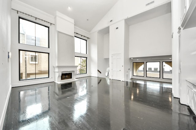1425 Nantucket Dr Unit G, Houston, TX 77057 - unfurnished living room featuring high vaulted ceiling and a fireplace with raised hearth