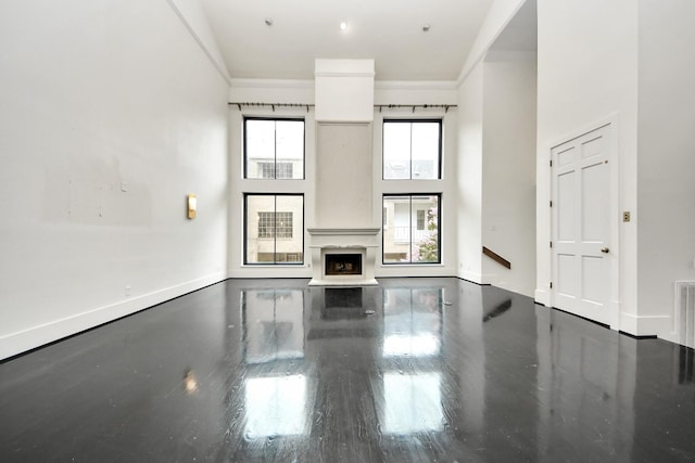1425 Nantucket Dr Unit G, Houston, TX 77057 - unfurnished living room with ornamental molding, a towering ceiling, and wood finished floors