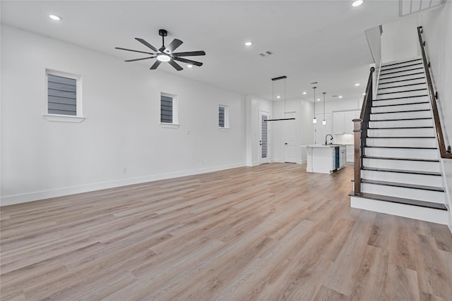 4517 Teton St, Houston, TX 77051 - unfurnished living room featuring a ceiling fan, light wood-type flooring, stairway, and recessed lighting