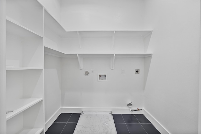 4517 Teton St, Houston, TX 77051 - laundry area featuring gas dryer hookup, electric dryer hookup, washer hookup, and dark tile patterned flooring