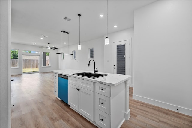 4517 Teton St, Houston, TX 77051 - kitchen featuring dishwashing machine, open floor plan, light wood-style flooring, white cabinets, and an island with sink