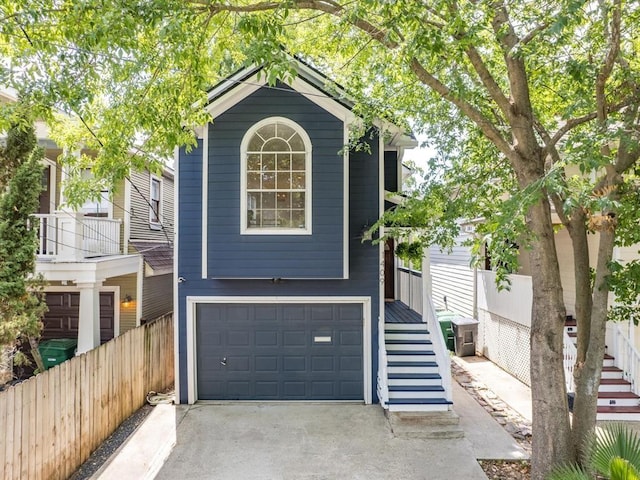 1409 Blair St, Houston, TX 77008 - view of front facade featuring a garage and asphalt driveway