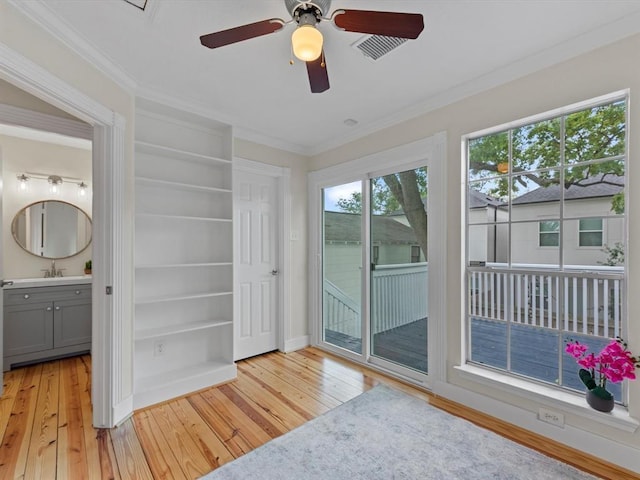 1409 Blair St, Houston, TX 77008 - unfurnished bedroom with light wood-style floors, access to exterior, crown molding, ensuite bathroom, and ceiling fan