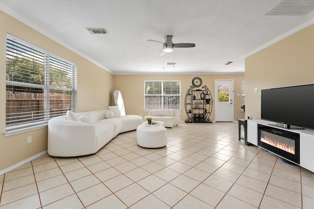 15026 Sunset Creek Dr, Humble, TX 77396 - living room featuring ceiling fan, crown molding, and light tile patterned flooring