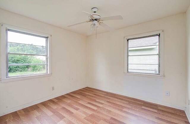 4310 Busiek St, Houston, TX 77022 - spare room with light wood-style floors and a ceiling fan