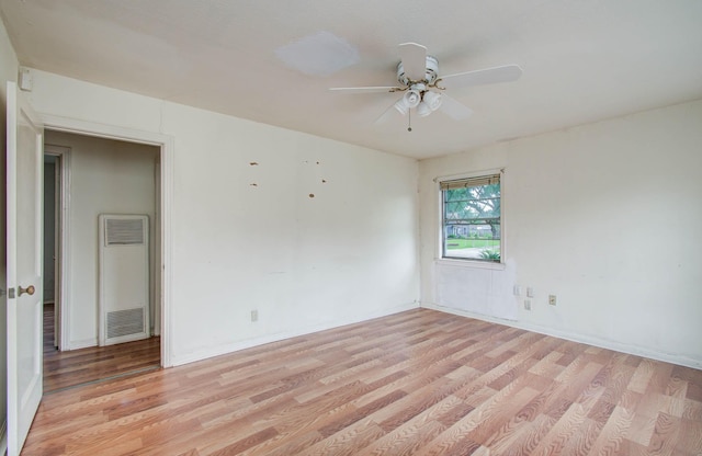 4310 Busiek St, Houston, TX 77022 - empty room featuring a heating unit, light wood finished floors, and a ceiling fan