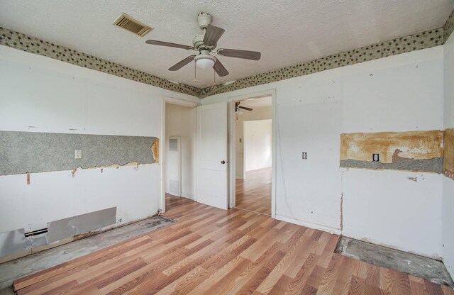4310 Busiek St, Houston, TX 77022 - spare room with a ceiling fan, wood finished floors, and a textured ceiling