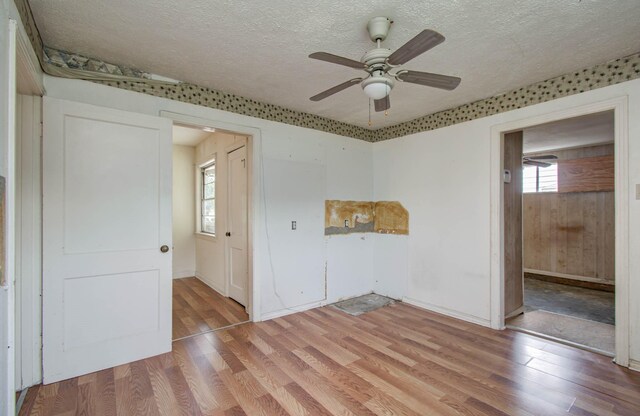 4310 Busiek St, Houston, TX 77022 - spare room with a textured ceiling, light wood finished floors, and ceiling fan