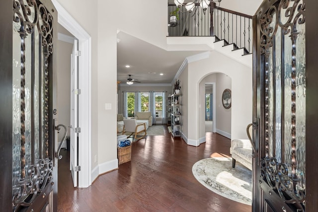 6051 Longmire Trl, Conroe, TX 77304 - foyer with arched walkways, ornamental molding, wood finished floors, ceiling fan, and a chandelier