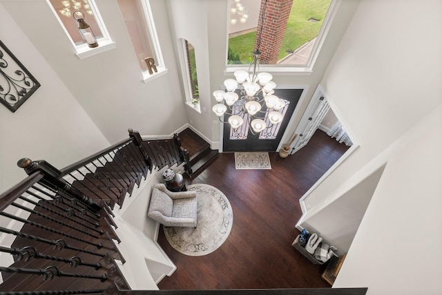 6051 Longmire Trl, Conroe, TX 77304 - foyer entrance with wood finished floors, a towering ceiling, a chandelier, and stairs