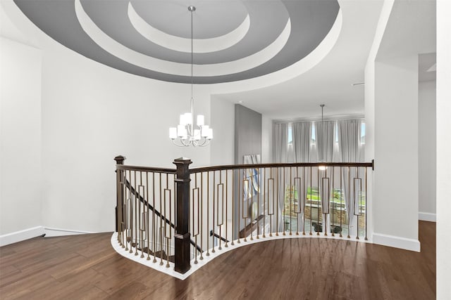 27915 Round Moon Ln, Katy, TX 77494 - hall featuring wood finished floors, a chandelier, an upstairs landing, a raised ceiling, and a towering ceiling