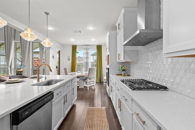 27915 Round Moon Ln, Katy, TX 77494 - kitchen with wall chimney exhaust hood, stainless steel appliances, white cabinetry, dark wood finished floors, and pendant lighting