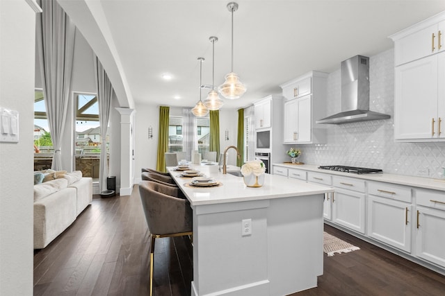 27915 Round Moon Ln, Katy, TX 77494 - kitchen with wall chimney range hood, appliances with stainless steel finishes, plenty of natural light, dark wood-style floors, and recessed lighting