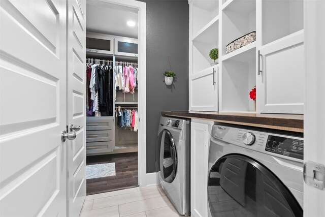 27915 Round Moon Ln, Katy, TX 77494 - washroom with washing machine and dryer, cabinet space, and light tile patterned floors