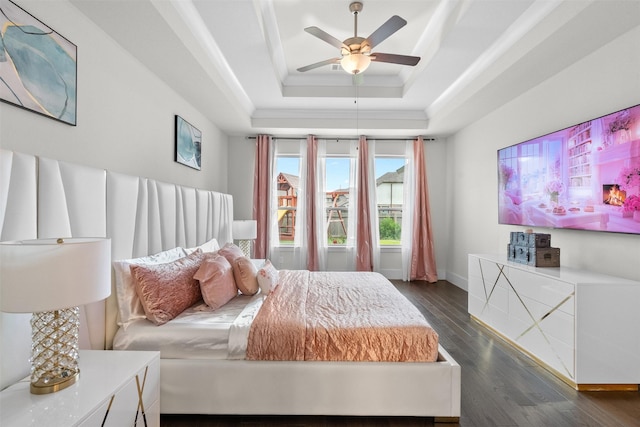 27915 Round Moon Ln, Katy, TX 77494 - bedroom featuring a tray ceiling, dark wood-style floors, and a ceiling fan