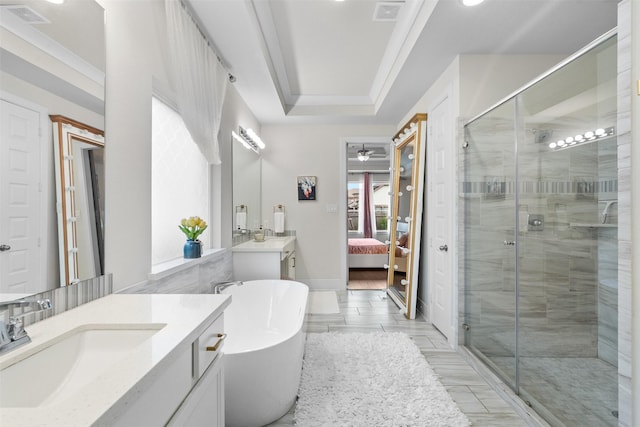 27915 Round Moon Ln, Katy, TX 77494 - ensuite bathroom with two vanities, a stall shower, a freestanding bath, a ceiling fan, and wood tiled floors