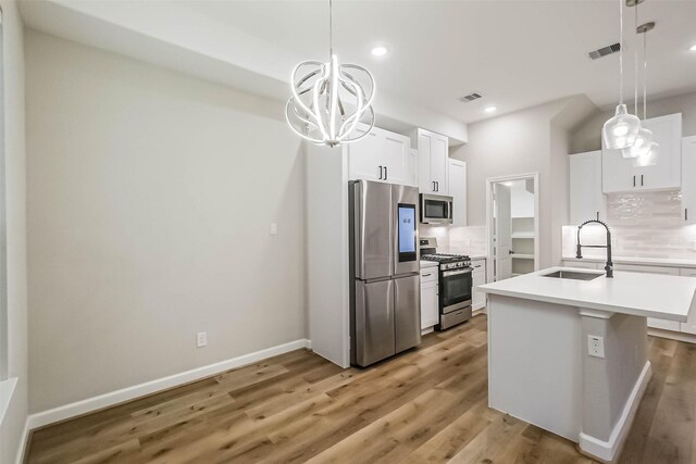 2353 Hoskins Dr, Houston, TX 77080 - kitchen with appliances with stainless steel finishes, a chandelier, decorative backsplash, light countertops, and recessed lighting