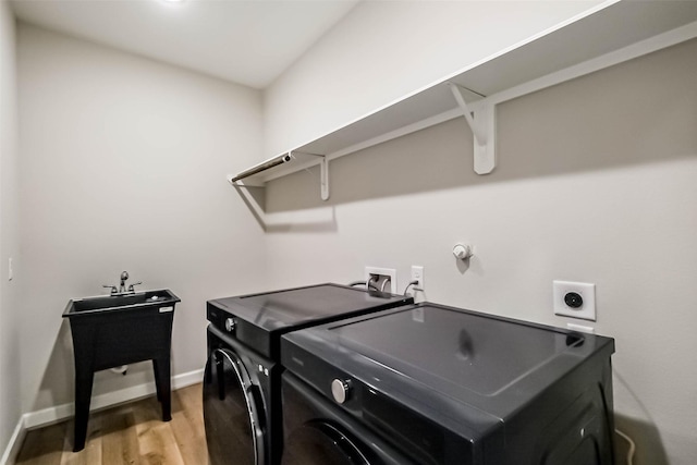 2353 Hoskins Dr, Houston, TX 77080 - laundry room featuring light wood-type flooring and washing machine and dryer