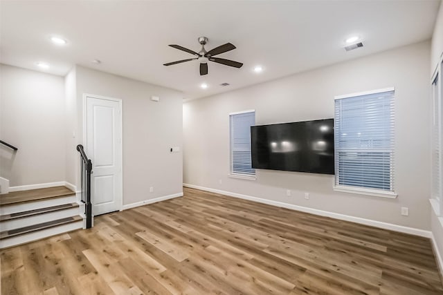 2353 Hoskins Dr, Houston, TX 77080 - unfurnished living room with wood finished floors, ceiling fan, stairway, and recessed lighting