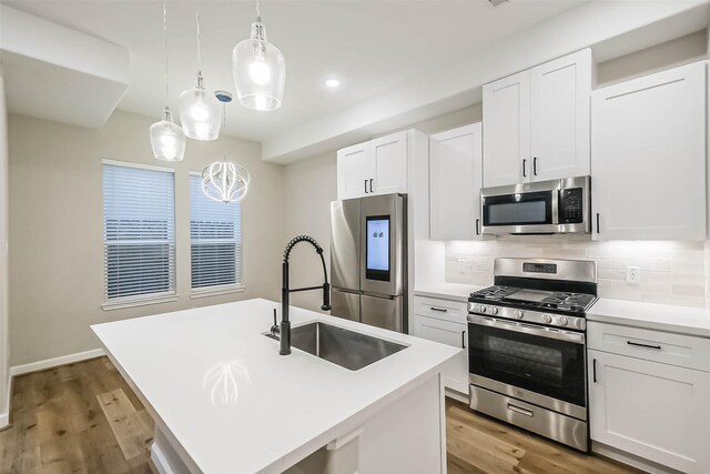 2353 Hoskins Dr, Houston, TX 77080 - kitchen featuring stainless steel appliances, light wood finished floors, backsplash, white cabinetry, and recessed lighting