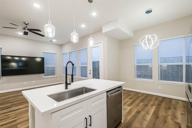 2353 Hoskins Dr, Houston, TX 77080 - kitchen with dishwasher, wood finished floors, white cabinets, light countertops, and recessed lighting