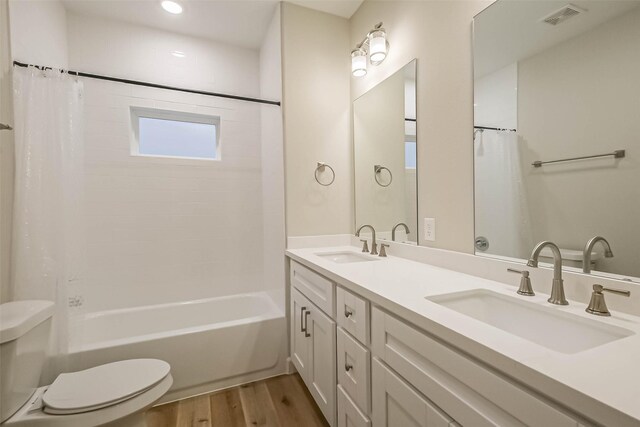 2353 Hoskins Dr, Houston, TX 77080 - bathroom featuring wood finished floors, double vanity, shower / tub combo, and recessed lighting