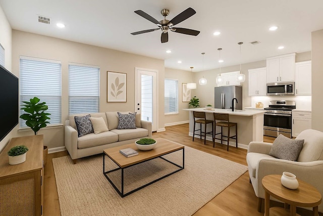2353 Hoskins Dr, Houston, TX 77080 - living room featuring ceiling fan, light wood-style flooring, and recessed lighting