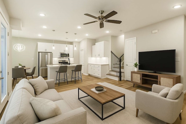 2353 Hoskins Dr, Houston, TX 77080 - living room with light wood-style flooring, recessed lighting, stairway, and ceiling fan