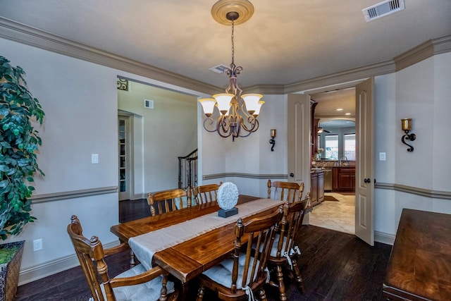 407 Pickney Ave, Sugar Land, TX 77479 - dining space featuring dark wood-type flooring, crown molding, and a chandelier