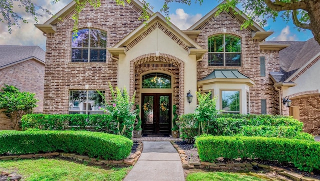 407 Pickney Ave, Sugar Land, TX 77479 - property entrance with french doors, brick siding, and stucco siding