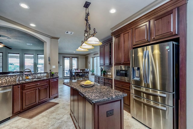 407 Pickney Ave, Sugar Land, TX 77479 - kitchen featuring stainless steel appliances, recessed lighting, a ceiling fan, tasteful backsplash, and dark stone countertops
